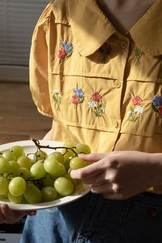 Short sleeve button up shirt with a peter pan collar and embroidered flowers all over the front chest. S: 37" chest, 22" lengthM: 38.5" chest, 22" lengthL: 40" chest, 22" length Summer Floral Embroidery Doll Collar Blouse, Summer Blouse With Floral Embroidery And Doll Collar, Floral Embroidered Doll Collar Blouse For Summer, Casual Blouse With Floral Embroidery And Peter Pan Collar, Spring Blouse With Peter Pan Collar And Buttons, Floral Embroidery Doll Collar Blouse For Summer, Spring Embroidered Blouse With Peter Pan Collar, Casual Embroidered Blouse With Peter Pan Collar, Embroidered Shirt With Collared Neckline For Spring