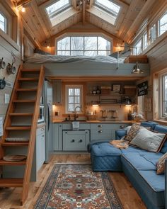 a living room filled with furniture next to a kitchen and lofted area in a house