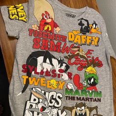 Looney Tunes Graphic Tshirt Kid Size 14/16. Nwot Playful Tops With Character Print For Fan Merchandise, Playful Short Sleeve Top For Fan Merchandise, Fun Graphic Print Tops For Fan Merchandise, Playful Cartoon Print Top For Fans, Gray Graphic Tee With Character Print, Fun Fan Merchandise Tops With Front Print, Fun Fan Merchandise Top With Front Print, Gray Cotton Tops With Character Print, Fun Character Print Tops For Streetwear