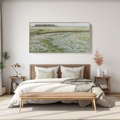 a bedroom with a bed, two tables and a painting on the wall above it