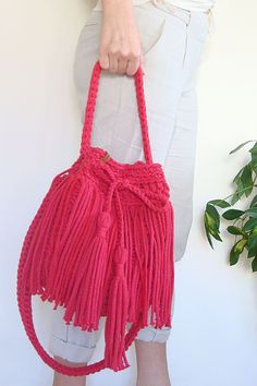 Hand crochet to order crossbody boho bag. Made with strong and durable, but soft cotton rope with fringes around. Choose your favourite color for the bag and lining with two deep pockets! Bohemian Pink Bucket Bag For The Beach, Pink Bohemian Bucket Bag For The Beach, Bohemian Pink Bucket Bag For Beach, Summer Bohemian Pink Bucket Bag, Bohemian Spring Crochet Bucket Bag, Spring Bohemian Woven Bucket Bag, Casual Summer Festival Bucket Bag, Bohemian Bucket Tote Bag With Tassels, Bohemian Bucket Bag Tote With Tassels