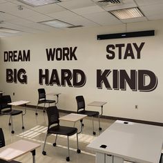 a classroom with desks and chairs in front of a wall that says dream work stay big hard kind