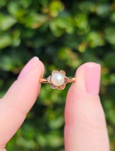 Elegant and dainty on the finger, this sweet vintage Pearl ring is a must for the June birthday girl, or perhaps a 3rd or 30th anniversary! Dating to 1972 and crafted from 9ct Yellow Gold which has a gleaming and warm hue and set in a unique flower setting with a single freshwater Pearl. The green and silver iridescence in this pearl contributes to the overall lustre and charm of this ring. Equally pretty we have the tapered shoulders that support the flower setting which then flow to the simple Vintage 14k Gold Flower Ring, Vintage 14k Rose Gold Flower Ring, Vintage Rose Gold 14k Gold Flower Ring, Vintage 14k Gold Flower Promise Ring, Vintage 14k Gold Flower Ring For Anniversary, Vintage 14k Gold Flower Ring For Gift, Vintage Rose Gold Rings With Birthstone, Vintage Rose Gold Birthstone Ring, Vintage Rose Gold Flower Ring