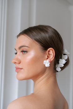 a woman wearing white flowers in her hair