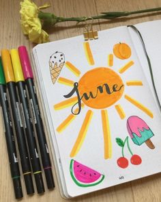 a notebook with the word june written on it next to some markers and pencils