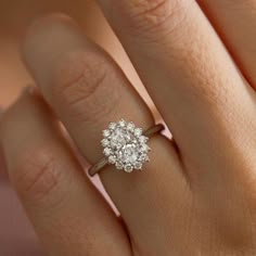 a woman's hand with a diamond ring on her finger and an engagement band