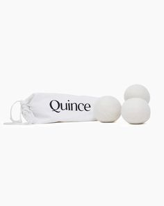 three white balls with the word quince written on them, sitting next to each other