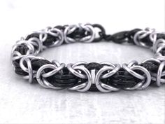 Classic Unisex Black and Platinum Silver Byzantine Anodized Aluminum Chainmaille Bracelet. I made it with care one ring at a time. Complete the effect by adding the Tierracast Lock and Key Toggle Clasp using this link and I'll include the charm for free: https://www.etsy.com/listing/1213157389 The bracelet can also act as a key holder for the matching Choker listed below! WRIST MEASUREMENT: When selecting the wrist measurement for you, please carefully measure your wrist where you intend to wear Black Stainless Steel Chainmail Jewelry, Black Punk Style Chain Bracelet As Gift, Punk Style Black Chain Bracelet Gift, Black Punk Style Chain Bracelet For Gift, Black Punk Chain Bracelet As A Gift, Adjustable Black Chainmail Jewelry, Black Hypoallergenic Metal Bracelets, Black Metal Hypoallergenic Bracelets, Hypoallergenic Black Metal Bracelets