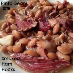 a white plate topped with beans and meat