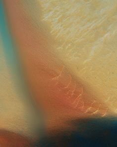 an abstract photograph of the ocean and sand