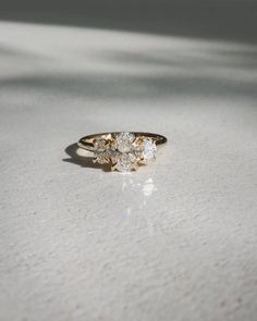 a three stone ring sitting on top of a table