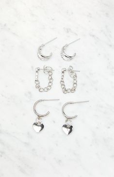 LA Hearts gives you options with the new 3 Pack Silver Earrings. This earring pack features three pairs of earrings in various designs and a silver finish.


	Includes 3 pairs of earrings
	Post back closure
	Silver finish Earring Pack, Y2k Earrings, Women Accessories Jewelry, Dainty Earrings, Pacsun, Earings Piercings, Post Earrings, Women's Accessories, Silver Earrings