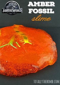 an orange substance with green lizards on it and the words amber fossil shine above it