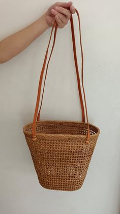 DescriptionCrafted from natural rattan, this purse effortlessly blends style and versatility. Whether you're headed to the beach or the grocery store, this eco-friendly bag is perfect for any occasion. MaterialsRattanLeather Brown Bamboo Handle Bucket Shoulder Bag, Rectangular Open Weave Bucket Bag, Brown Straw Bag With Bamboo Handle In Bucket Shape, Casual Bucket Bags With Bamboo Handle, Eco-friendly Bucket Bags With Bamboo Handle, Brown Bamboo Handle Straw Bucket Bag, Natural Color Bucket Shoulder Bag For Daily Use, Natural Rattan Shoulder Bag For Daily Use, Casual Brown Rattan Bucket Bag