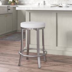 a white stool in a kitchen next to a counter