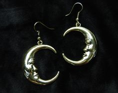 Are you tired of those ordinary earrings that just don't cut it when it comes to showcasing your celestial spirit with the perfect blend of boho chic and celestial sparkle?  Look no further because these Gold Tone Moon-Faced Crescent Dangle Earrings are here to rocket your style into a new galaxy.  These earrings are mirror images of each other. Embrace your inner moon goddess with these cosmic beauties. Celestial Spirit, Moon Goddess, Moon Earrings, Cut It, Mirror Image, Etsy Earrings Dangle, Columbus, Crescent, Rocket