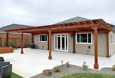 an outdoor patio with a pergolan attached to it