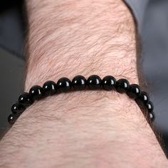 Handsome men's bracelet made with black onyx beads and sterling silver clasp. Classic Black Bracelets With 8mm Beads, Classic Black Beaded Bracelets As Gift, Elegant Hand-strung Bracelets, Classic Onyx Beaded Bracelets With Adjustable Fit, Classic Black Onyx Bracelets, Classic Black Onyx Bracelet, Classic Black Beaded Bracelets, Modern Black Bracelets With Gemstone Beads, Classic Adjustable Black Bead Bracelets