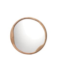 a round wooden mirror hanging on the wall above it's reflection, with a white background