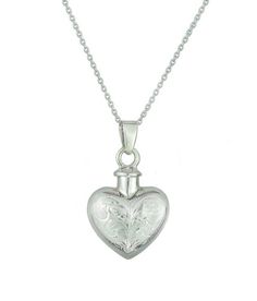 This sterling silver pendant is made into the shape of a heart with intricate hand carved vintage patterns.It is designed to hold a small amount of a loved one or pet’s ashes as it is hollow inside, ensuring that there is always a part of them held close to your heart.Measuring approximately 2cm/0.78inches in height and 1.8cm/0.70inches in width.The solid 925 Sterling Silver chain measures approximately 46cm (18.1”).Each Pendant comes beautifully presented in its own gift box with a silver polis Pet Ashes Jewelry, Urn Pendant, Ashes Jewelry, Keepsake Urns, Motif Vintage, Vintage Heart, 925 Sterling Silver Chain, Engraved Items, Diamond Heart