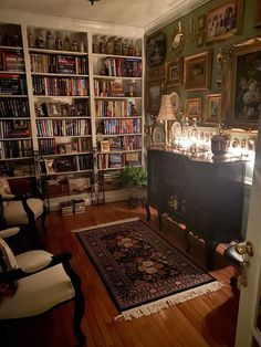 a room filled with lots of books and furniture