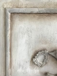 an old photo frame with a bird on it's side and the word love written in