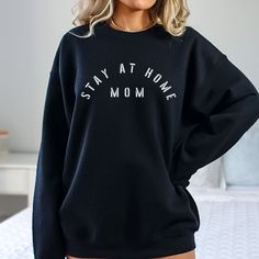 The Stay At Home Mom Crewneck Sweatshirt is perfect for a home maker mama!  I love working with custom orders!  If you have a design in mind, or have something customized already and would like it on a shirt, send me a message and we can make that happen! This item is printed with ink through a partnership with a print company.  It's not one of the hand-painted items in this shop.  Therefore, I have not personally inspected it before it's shipped, or packed with the extra care I give each order. Cozy Black Sweater With Letter Print, Comfy Oversized Top With Letter Print, Cozy Black Top With Letter Print, Comfortable Relaxed Fit Tops For Home, Comfy Letter Print Sweatshirt For Everyday, Comfy Everyday Tops With Letter Print, Oversized Comfortable Sweatshirt With Letter Print, Oversized Comfy Sweatshirt With Letter Print, Cozy Sweater With Letter Print And Relaxed Fit