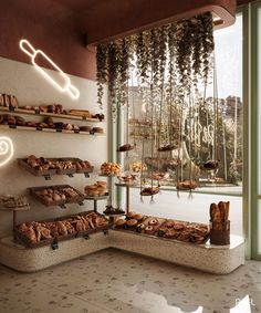 a display case filled with lots of pastries next to a window covered in hanging plants