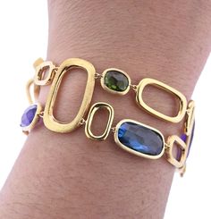 Marco Bicego Murano collection 18K yellow gold link bracelet, set with amethyst, citrine, peridot, topaz, tourmaline gemstones. DESIGNER: Marco Bicego MATERIAL: 18K Yellow Gold GEMSTONE: Spessartite garnet, Amethyst, Topaz, Peridot, Citrine CLARITY/COLOR: n/a MEASUREMENTS: Bracelet is 7" long x 1" wide MARKED/TESTED: Marco Bicego Made in Italy; Italian mark, 750 WEIGHT: 27.0 grams CONDITION: New PRODUCT ID: OG-1033 Bracelets With Gemstones, Modern Gold Multi-stone Gemstones, Modern Gold Multi-stone Jewelry, Gold Fusion Multi-stone Bracelets, Modern Yellow Gold Jewelry With Stones, Modern Gold Bracelet With Multi-stone, Italian Gold Jewellery Design, Dimond Breslet, Italian Jewellery Design