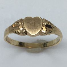 Antique Heart Shape 14K GOLD Signet RIng 1.0 Gram Size 5.25 Never Engraved This antique signet ring is a true beauty. Crafted from 14k yellow gold, it features a heart-shaped design that exudes elegance and sophistication. The ring is perfect for any occasion and is a great addition to any jewelry collection. With a weight of 1.0 gram and a size of 5.25, this ring is a perfect fit for anyone. It has never been engraved and does not feature any diamonds or gemstones. The vintage design adds to its charm and makes it a unique piece. Don't miss out on the opportunity to own this exquisite piece of fine jewelry. 6 mm wide on top Vintage Gold Signet Ring, Victorian Yellow Gold Engraved Ring With Polished Finish, Heirloom 14k Gold Heart Promise Ring, Victorian Engraved Ring With Polished Finish In 14k Gold, Victorian Style Yellow Gold Signet Ring With Polished Finish, Victorian 14k Gold Engraved Ring With Polished Finish, Antique Signet Ring With 17 Jewels For Anniversary, 14k Gold Heart Ring With Polished Finish For Wedding, Classic Gold Signet Ring For Promise