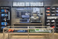 the inside of a shoe store with shoes on display