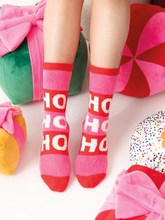 Make a statement with your style in Shiraleah’s “Ho Ho Ho” Socks. These adorable mid-calf height socks feature a thick striped pattern of pink and red with the words “Ho Ho Ho” on the front of both socks in bright white letters. Made from soft and luxurious fabric, they will be your favorite pair to wear while opening presents and celebrating the season in style. Pair with other items from Shiraleah’s Merry Everything Collection to complete your look! Shiraleah is a trend-driven lifestyle brand Pink Winter Socks As Gift, Pink Socks For Winter Stocking Stuffers, Fun Pink Socks For Stocking Stuffers, Pink Winter Socks For Gift, Pink Super Soft Socks For Gift, Cozy Pink Socks For Gifts, Fun Pink Socks For Winter, Comfortable Pink Socks For Gifts, Playful Red Socks For Winter