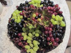 a platter filled with grapes and other fruits