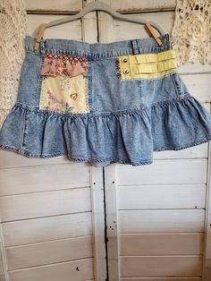 "American Eagle 100% cotton denim ruffled mini-skirt, size XXL.  Uniquely upcycled using vintage fabrics.  All sewing is done by hand as well as embroidery embellishments.  Waist gathers with elastic and measures approximately 36\" around at rest, length is approximately 15.5\" long." Medium Wash Cotton Skirt With Patchwork, Cotton Denim Mini Skirt With Ruffles, Cotton Skirt With Patchwork In Medium Wash, Cotton Patchwork Mini Skirt, Casual Cotton Mini Skirt With Patchwork, Bohemian Cotton Mini Skirt With Ruffles, Bohemian Cotton Ruffles Mini Skirt, Bohemian Cotton Ruffled Mini Skirt, Bohemian Cotton Ruffle Mini Skirt