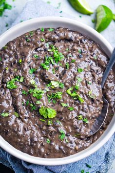 a bowl filled with black beans and cilantro garnished with parsley