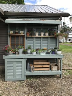 an outdoor potting shed with pots and plants on it