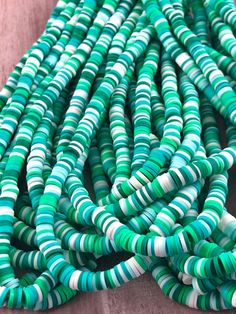 green and white striped beads are stacked together