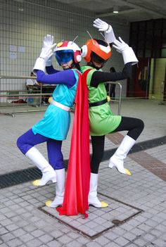 two people dressed as super heros pose for the camera