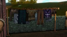 clothes are hanging on a clothes line in a virtual world environment, with trees and mountains in the background