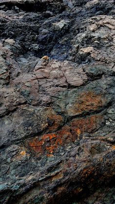 an image of rocks with different colors and patterns on them in the daytime sun or night