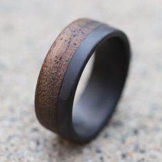 a black ceramic ring with wood inlays