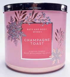 bath and body works champagne toast scented candle with essential oils in pink tin on white background