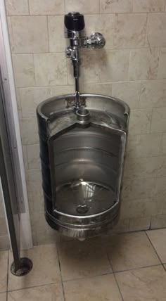 a urinal in a public restroom with tile walls and flooring on the wall