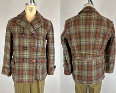 "You'll look the part of a ruggedly handsome outdoorsman in this toasty wool barnstormer jacket from the 1930s!  It's made of a thick wool woven into a bold plaid of hickory brown, rust orange, forest green, and beige.  There are two hand warmer pockets at the chest, two large pockets at the hip, double breasted leather knot button front closure, ventless belted back with pleats into the belt, and prominent notched collar.  Made by \"Double Duty.\"  This jacket is in great vintage condition with Brown Buttoned Sport Coat For Fall, Brown Sport Coat With Buttons For Fall, Outdoor Fall Blazer With Button Closure, Fall Outdoor Blazer With Button Closure, Fitted Tweed Pea Coat For Fall, Brown Double-breasted Tweed Outerwear, Fitted Vintage Outdoor Outerwear, Vintage Pea Coat With Buttons For Fall, Vintage Outdoor Sport Coat For Fall