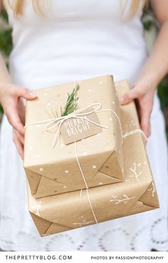 a woman holding two wrapped presents in her hands