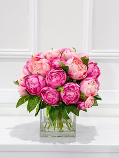 a vase filled with pink flowers on top of a table