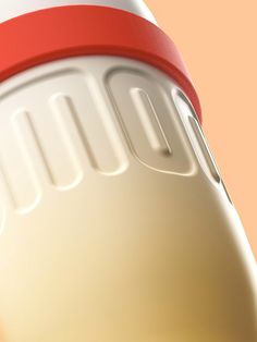 a red and white blender sitting on top of a pink table next to an orange wall