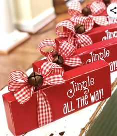 two red wooden boxes with bows on them