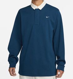 Elevate your athletic style with this Nike Sportswear Rugby Top Solo Swoosh. This blue collared polo shirt features a solid pattern and long sleeves, perfect for any casual occasion. Made with a comfortable knit fabric of 98% cotton and 2% spandex, this shirt fits regular with a size type of regular. It also boasts the iconic Nike Swoosh logo, representing the brand's top-quality performance and activity. This shirt is ideal for sports events or a day out and about. Get yours now! Nike Swoosh Logo, Concept Clothing, Athletic Style, Swoosh Logo, Nike Swoosh, Shirt Fits, Rugby Shirt, Athletic Fashion, Out And About