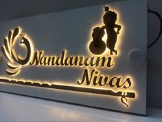 an illuminated sign that says nandanan niwas on the side of a wall